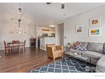 Comfortable living room featuring hardwood floors, stylish decor, and an open layout at 4451 S Ammons St # 307, Littleton, CO 80123