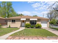 Charming brick home with well-manicured lawn, inviting walkway, and single-car garage at 7736 Vallejo St, Denver, CO 80221