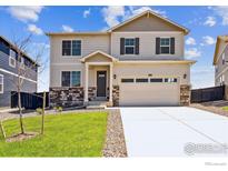 Charming two-story home with a stone-accented facade and well-maintained lawn at 9902 Cathay St, Commerce City, CO 80022