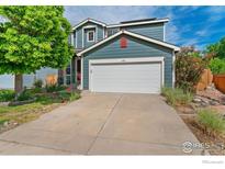 Inviting two-story home with a two-car garage and charming curb appeal at 1086 Mockingbird St, Brighton, CO 80601