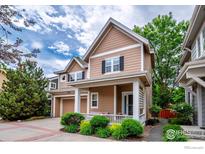 Charming two-story home with a welcoming front porch and well-maintained landscaping at 13255 Red Deer Trl, Broomfield, CO 80020
