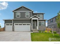 Charming two-story home with a two car garage, manicured lawn, and welcoming front entrance at 1800 Vantage Pkwy, Berthoud, CO 80513