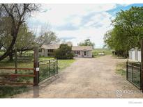 Charming ranch-style home with a well-maintained yard and gravel driveway at 2091 Tate Ave, Fort Lupton, CO 80621