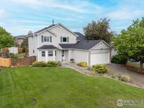 Charming two-story home featuring a well-manicured lawn and an attached two-car garage at 2144 Santa Fe Dr, Longmont, CO 80504