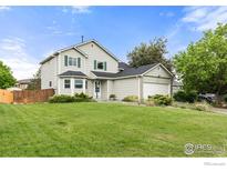 Charming two-story home features a well-manicured lawn and a two-car garage at 2144 Santa Fe Dr, Longmont, CO 80504