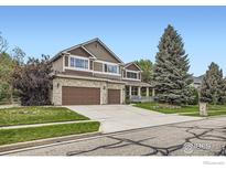 Charming two-story home with a three-car garage and well-manicured lawn at 2215 Parkview Dr, Longmont, CO 80504