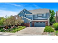 Charming two-story home with a well-maintained front yard and attached two-car garage at 23570 E Holly Hills Way, Parker, CO 80138
