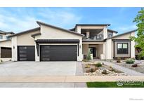 Stunning contemporary home with a three-car garage, black framed windows and professionally landscaped front yard at 2712 Bluewater Rd, Berthoud, CO 80513
