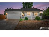 Charming single-story home with a covered front porch, a stone-accented garage, and low-maintenance landscaping at 3557 Settler Ridge Dr, Mead, CO 80542