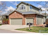 Charming home featuring a brick facade, attached two car garage, and well maintained lawn at 4094 Bimini Ct, Boulder, CO 80301