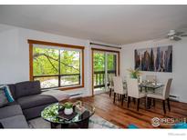 Bright living room featuring a modern sectional sofa, round glass table, and view to the outside at 827 Maxwell Ave # H, Boulder, CO 80304