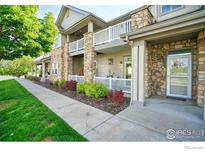 Well-maintained condo exterior with lovely landscaping, stone accents and covered balconies at 10818 Cimarron St # 1203, Firestone, CO 80504