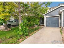 Charming two-story home with a driveway leading to an attached one-car garage at 11096 Claude Ct, Northglenn, CO 80233