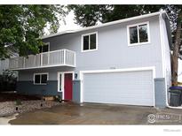 Charming two-story home featuring a second story balcony, a spacious garage, and a red front door at 1714 Zeus Dr, Lafayette, CO 80026