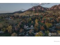 Breathtaking aerial view of home nestled against mountains with lush trees at 2100 Kohler Dr, Boulder, CO 80305