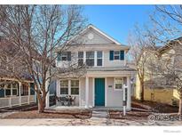 Charming two-story home with a well-manicured front yard and inviting porch on a beautiful sunny day at 2362 Xanthia Way, Denver, CO 80238