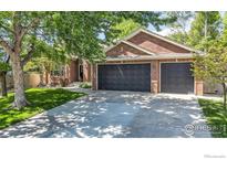 Charming brick home featuring a large driveway and two-car garage at 2563 Otter Ct, Lafayette, CO 80026