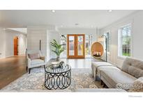 Open concept living room offers comfortable seating, stylish rug and double doors at 2970 21St St, Boulder, CO 80304