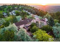 Stunning multi-story home with expansive windows nestled amongst lush greenery at 495 S Cedar Brook Rd, Boulder, CO 80304