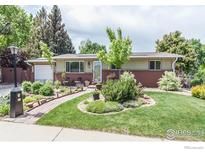 Charming single-story home featuring a well-manicured lawn and lovely landscaping at 501 Copeland Way, Longmont, CO 80504