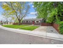 Charming single-story home with a brick facade, red front door, and a well-maintained lawn at 518 Sunset Dr, Louisville, CO 80027