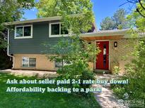 Charming two-story home with a red front door and a well-maintained landscaped front yard at 5355 Kewanee Dr, Boulder, CO 80303