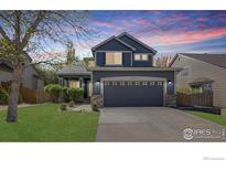 Charming two-story home boasts a well-manicured lawn and an attached two-car garage at 5822 Shenandoah Ave, Firestone, CO 80504