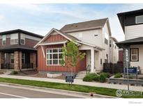 Well-manicured two-story home with a tidy front yard and inviting front entrance at 730 Promenade Dr, Superior, CO 80027