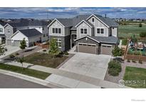 Stunning two-story home showcasing a manicured front yard and a three-car garage at 913 Green Mountain Dr, Erie, CO 80516