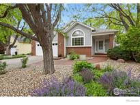 Beautiful home with well-maintained landscaping, brick accents, and a welcoming entrance at 1279 Cressida Ct, Lafayette, CO 80026