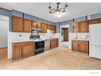 Traditional kitchen featuring wood cabinets, a white countertop, and vintage appliances at 1380 Ithaca Dr, Boulder, CO 80305