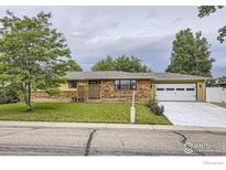 Charming one-story home with a brick facade, green lawn and mature shade tree in a quiet neighborhood setting at 1510 22Nd Ave, Longmont, CO 80501