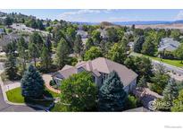 Stunning aerial view of home featuring mature trees and well-manicured landscaping at 1977 Champions Cir, Castle Rock, CO 80104