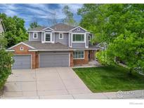 Charming two-story home with a three-car garage and well-maintained lawn surrounded by mature trees at 2204 Lasalle St, Superior, CO 80027