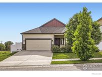 Charming single-story home with a well-maintained lawn and a two-car garage at 3572 Lissa Dr, Berthoud, CO 80513