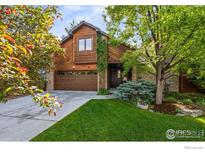 Charming home with a well-maintained lawn, mature trees, and a two-car garage at 5430 Baca Cir, Boulder, CO 80301