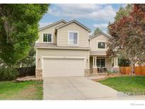 Charming two-story home featuring a two-car garage and manicured front yard at 804 Nelson Park Ln, Longmont, CO 80503