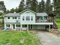 Charming two-story home boasts a spacious deck and scenic views, perfect for relaxing outdoors at 849 Mountain Meadows Rd, Boulder, CO 80302
