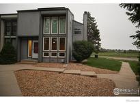 Modern townhome with unique window features and low maintenance rock landscaping in the front at 10350 Tumbleweed Dr # 32, Thornton, CO 80229