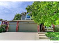 Charming two-story home featuring a well-maintained lawn, mature trees, and a spacious three-car garage at 11535 Briarwood Ln, Parker, CO 80138