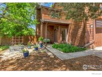 Charming wood-sided home with beautiful landscaping, vibrant greenery, and inviting curb appeal at 2617 Juniper Ave, Boulder, CO 80304
