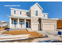 Two-story home under construction with two-car garage, covered porch, and beige siding at 2718 Crystal Springs Ln, Longmont, CO 80503
