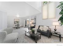 Bright living room with modern decor, including a sofa, coffee table, and dining area at 2835 S Monaco Pkwy # 104, Denver, CO 80222