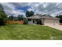 Charming single-story home with a manicured lawn and a welcoming two-car garage at 13112 Summit Grove Pkwy, Thornton, CO 80241