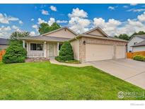 Charming single-story home with a manicured lawn and a two car garage at 13112 Summit Grove Pkwy, Thornton, CO 80241
