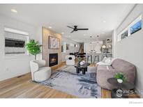 Bright living room featuring a modern fireplace, stylish furniture, and an open floor plan at 1578 Lowell Blvd # 1, Denver, CO 80204