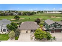 Beautiful home with a three-car garage, landscaping, and backing to a golf course at 1826 Lochmore Dr, Longmont, CO 80504