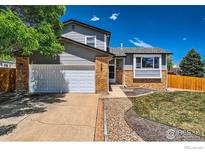 Charming two-story home with a well-maintained lawn and a two-car garage at 2447 E 100Th Way, Thornton, CO 80229