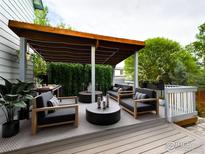Relaxing back patio with covered seating area, stylish furniture, and privacy landscaping at 2720 E 121St Pl, Thornton, CO 80241