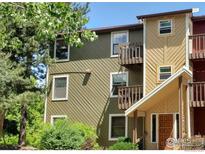 Two-story condo with multiple windows and small private balconies at 2855 Shadow Creek Dr # 302, Boulder, CO 80303